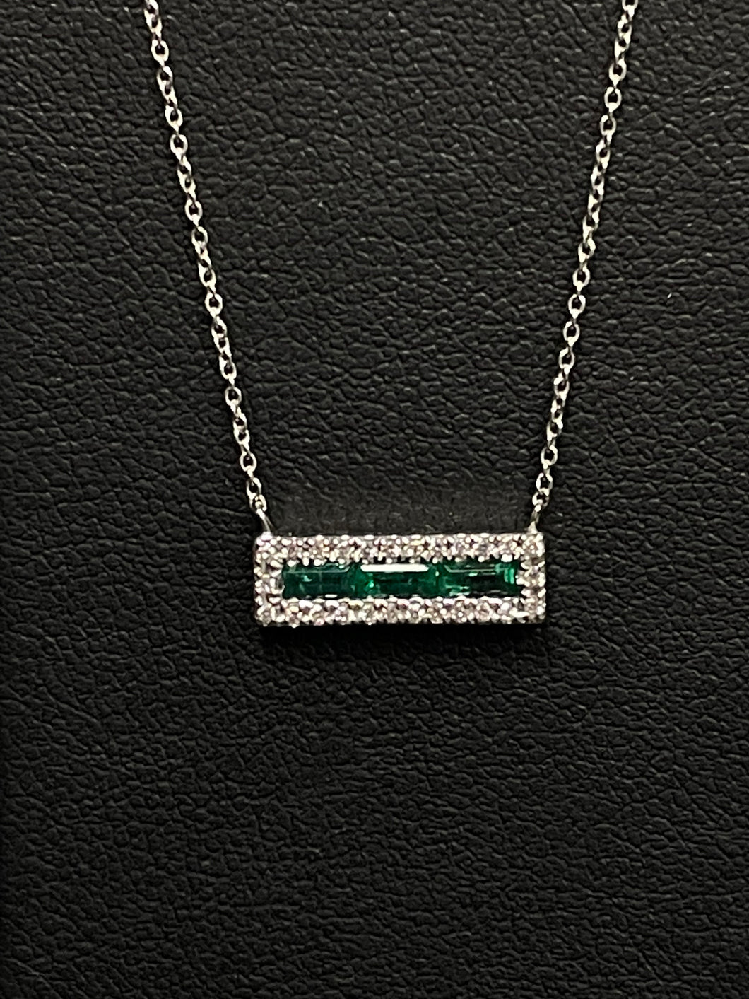 One Ladies 14k White Gold Emerald and Diamond Pendant on and adjustable 16